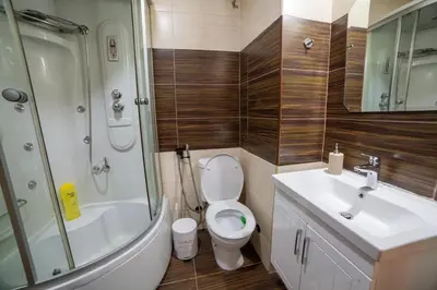 a bathroom with a toilet and a sink and a shower at Podgorica Boulevard Residence in Podgorica