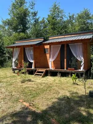 a log cabin with a porch in a yard at Ada in Ulcinj