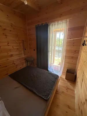 a room with a bed in a wooden cabin at Ada in Ulcinj