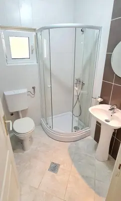 a bathroom with a shower and a toilet and a sink at Apartment Dragicevic 9 - with garage in Budva