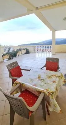 a table and chairs on a patio with a view at Apartment Dragicevic 9 - with garage in Budva