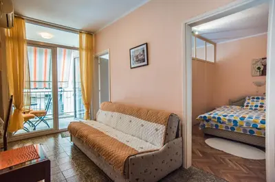 a living room with a couch and a bed at Budva Apartment in Budva