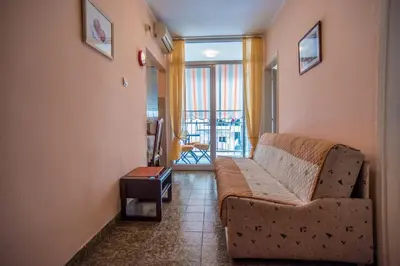 a living room with a couch and a balcony at Budva Apartment in Budva