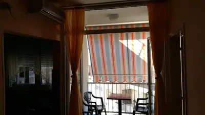a sliding glass door with a table and chairs outside at Budva Apartment in Budva