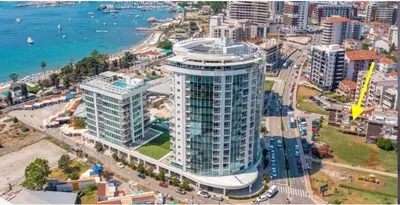 an aerial view of a tall building next to the ocean at Budva Apartment in Budva