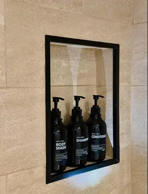 a shelf on a wall with four bottles of soap at LuxEcoCottage in Podgorica