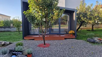 a small tree in the front of a tiny house at LuxEcoCottage in Podgorica