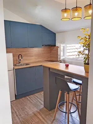 a kitchen with blue cabinets and a counter with a sink at Little Heaven Escape in Budva