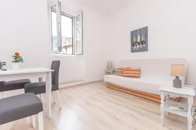 a white room with a bed and a table at Central & quiet location inside Old town Kotor in Kotor