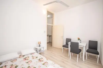 a bedroom with a table and chairs and a bed at Central & quiet location inside Old town Kotor in Kotor