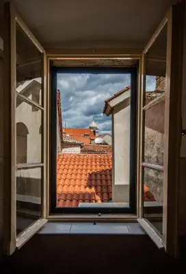 a window with a view of a tile roof at Central & quiet location inside Old town Kotor in Kotor
