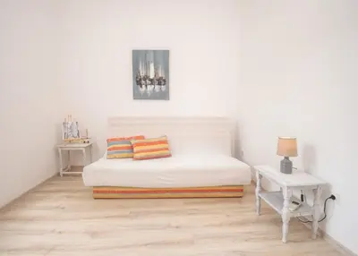 a white room with a bed with two pillows on it at Central & quiet location inside Old town Kotor in Kotor