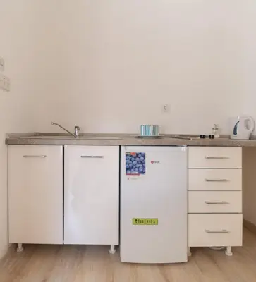 a kitchen with white cabinets and a counter top at Central & quiet location inside Old town Kotor in Kotor