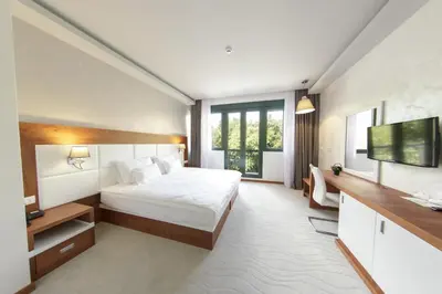 a hotel room with a bed and a television at Hotel Porto In in Kotor