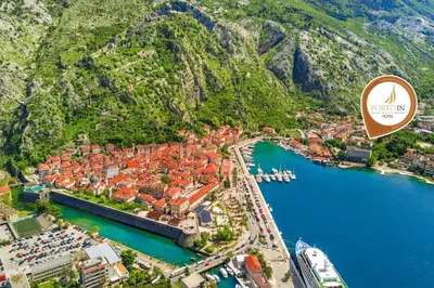 an aerial view of a city with a harbor at Hotel Porto In in Kotor