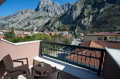 a balcony with a view of a mountain at Hotel Porto In in Kotor