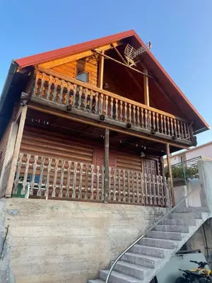 a house with a staircase in front of it at Vikendica za odmor in Dobra Voda