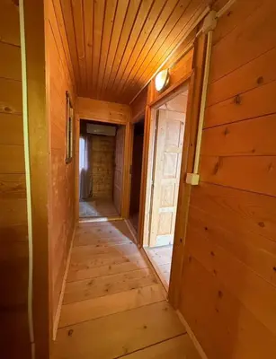 a hallway in a wooden cabin with a door at Vikendica za odmor in Dobra Voda