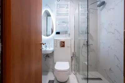 a bathroom with a toilet and a sink and a shower at LOLA Apartments in Podgorica