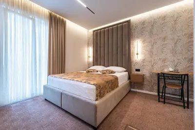 a hotel room with a bed and a window at LOLA Apartments in Podgorica