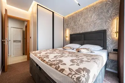 a bedroom with a large bed with two pillows at LOLA Apartments in Podgorica