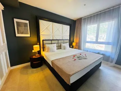 a bedroom with a large bed and a large window at Azure Corner Residence Budva - Seaside Living Apartments in Becici