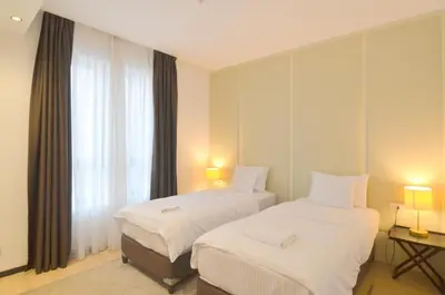 a hotel room with two beds and a window at Azure Corner Residence Budva - Seaside Living Apartments in Becici