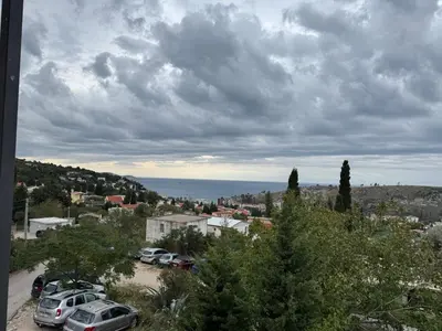 a group of cars parked in a parking lot at Apartmani in Sutomore