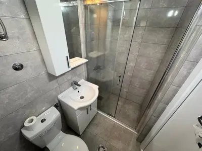 a bathroom with a shower and a toilet and a sink at Apartmani in Sutomore