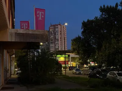 a city at night with cars parked on a street at Gintas Comfort in Podgorica