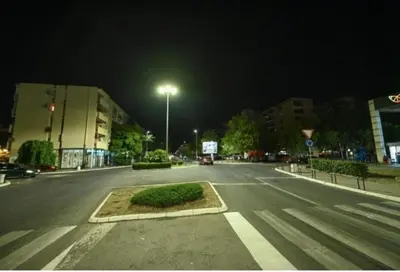 an empty street at night with a street light at Gintas Comfort in Podgorica
