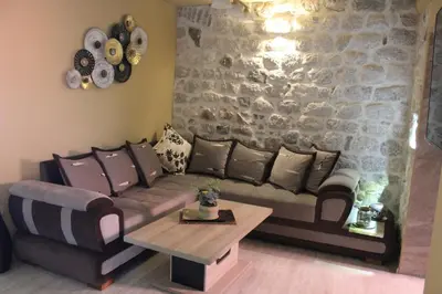 a living room with a couch and a table at Piano apartments in Kotor