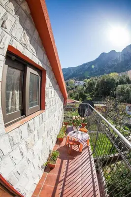 a balcony of a building with a table and chairs at Piano apartments in Kotor