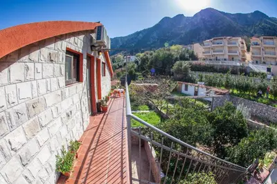 a balcony of a building with mountains in the background at Piano apartments in Kotor