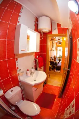 a bathroom with a white toilet and a sink at Piano apartments in Kotor