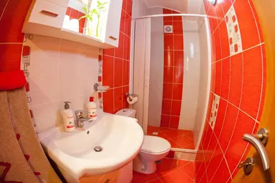 a bathroom with a white sink and a toilet at Piano apartments in Kotor