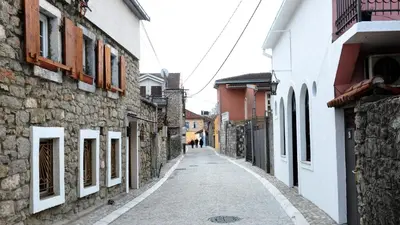 an alley in an old town with buildings at Art House Old Town in Podgorica