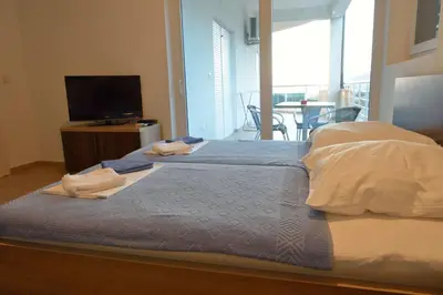 a bedroom with a bed with two towels on it at Belvedere Apartments with Seaview in Dobra Voda