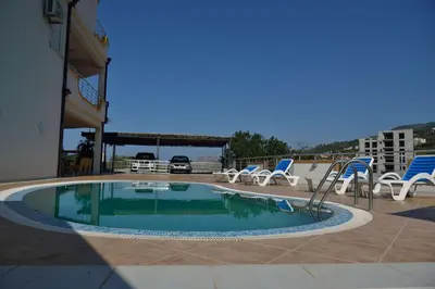 a small swimming pool with chairs at Belvedere Apartments with Seaview in Dobra Voda