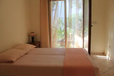 a bedroom with a bed and a large window at 4M Apartments in Petrovac na Moru