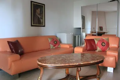 a living room with an orange couch and a table at 4M Apartments in Petrovac na Moru