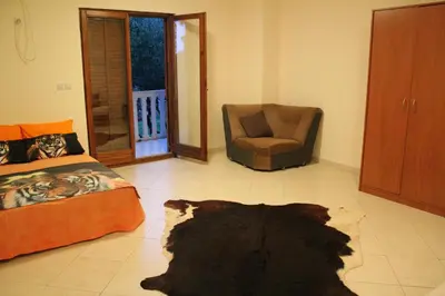 a living room with a couch and a chair at 4M Apartments in Petrovac na Moru