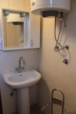a bathroom with a sink and a mirror at 4M Apartments in Petrovac na Moru