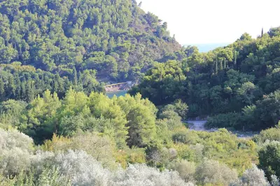 a view of a mountain with a train going through it at 4M Apartments in Petrovac na Moru