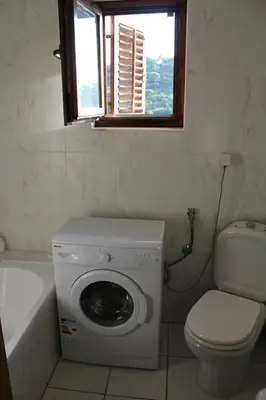 a bathroom with a washing machine and a toilet at 4M Apartments in Petrovac na Moru