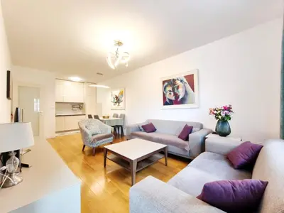 a living room with a couch and a table at Central Point Apartment in Podgorica