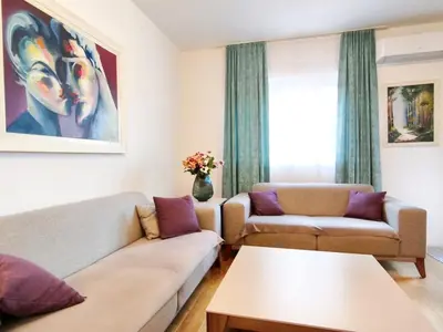 a living room with a couch and a table at Central Point Apartment in Podgorica