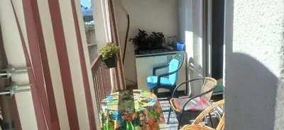 a balcony with a table and chairs on a balcony at Cozy city center apartment in Podgorica