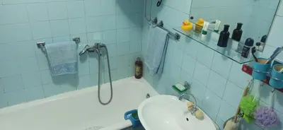 a bathroom with a shower with a toilet and a sink at Cozy city center apartment in Podgorica