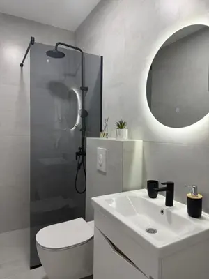 a bathroom with a sink and a toilet and a mirror at Apartmani Zabjelo in Podgorica